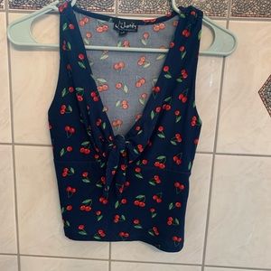 Dark blue crop top with cherries pattern. Only worn once.